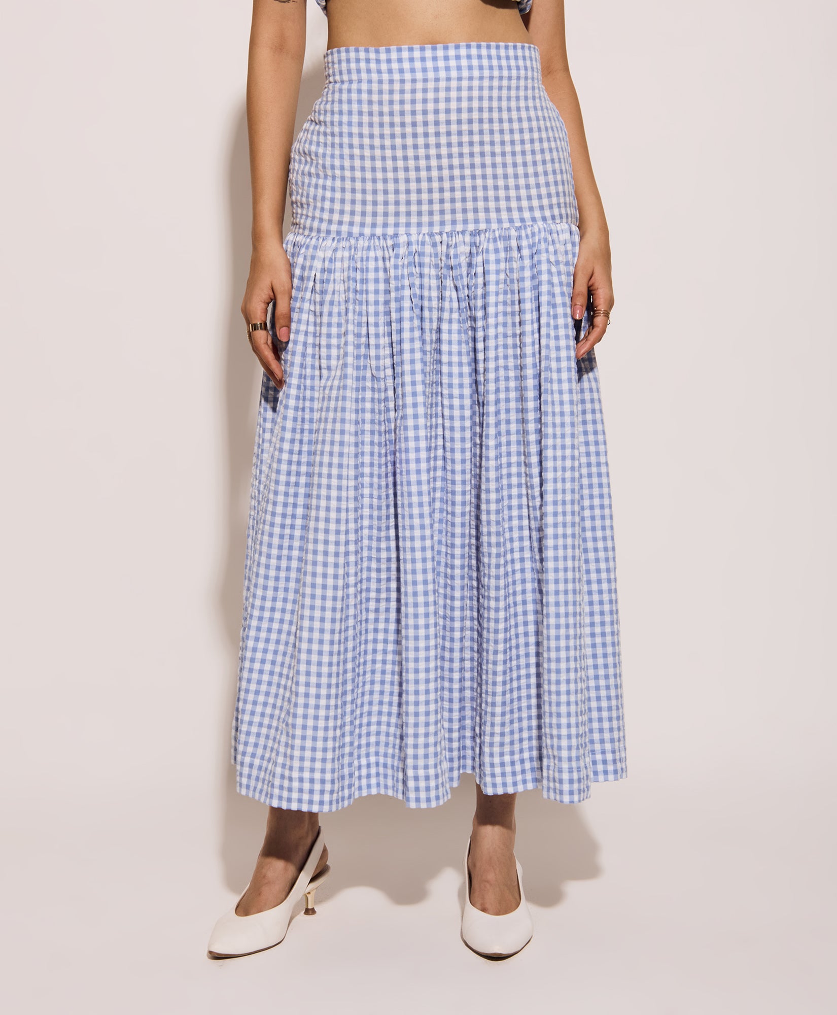 Model wearing classic blue gingham cotton skirt